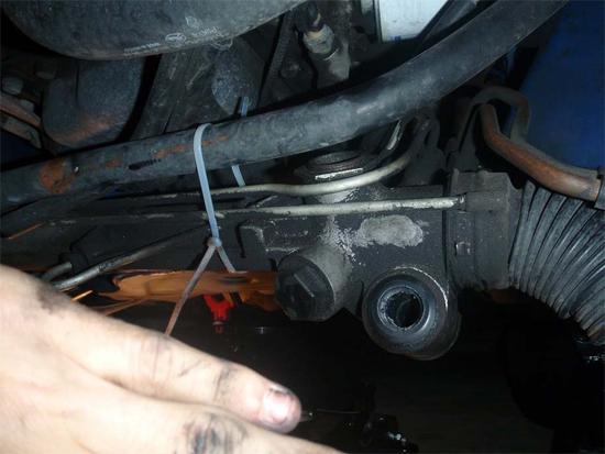 12. Now you need to disconnect the steering rack from the K-member and zip-tie it to the sway bar. There are two bolts holding the steering rack in place.