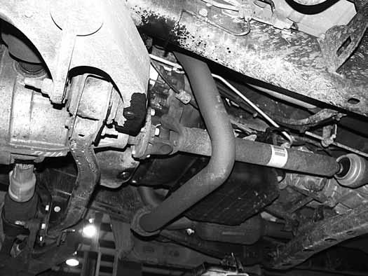 23. Locate the exhaust crossover pipe. If the crossover pipe runs under the front driveshaft it must be modified (Fig 6).