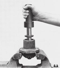 Secure assembly in a vise as shown in Figure 8 and tighten lock nut enough to draw down gear and washer until the bearings bind. Nut is then backed off slightly (approx. 1/ turn).