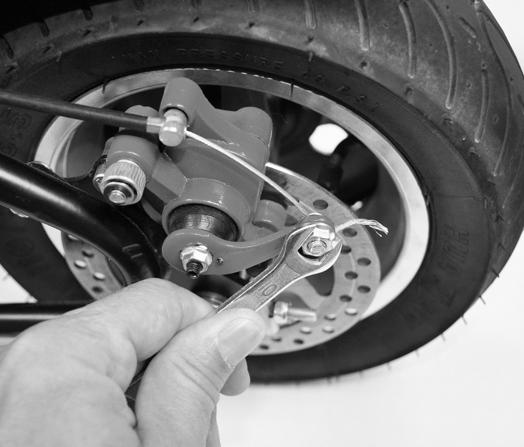 MAINTAINING YOUR MINI BIKE ADJUSTING THE BRAKE (CONTINUED) OPTION 2: Adjust using the actuator arm on the brake caliper.