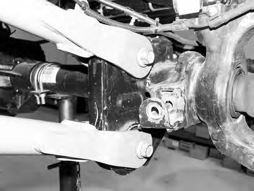 Install the new lower control arm in the new frame bracket with a ¾ x 5-1/2 bolt, nut and ¾ SAE flat washers. Install arm so that the grease fitting is up. Leave hardware loose. 37.