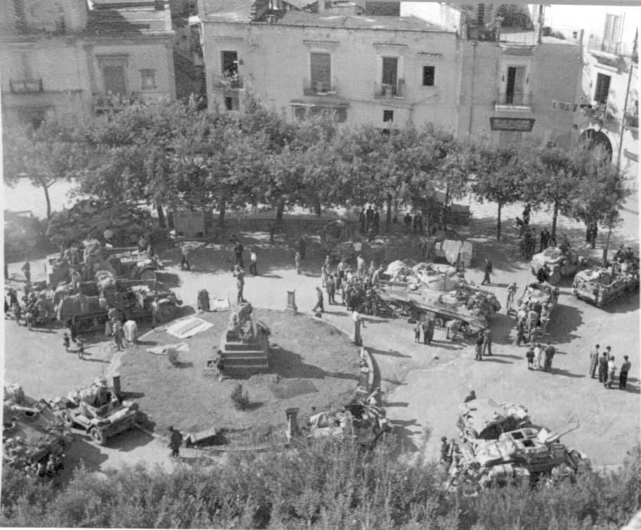 (Photo sourced from Sharpshooter House, Croydon) 5th Army, 4th CLY Sherman tanks halted in the town square at