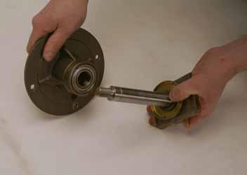 Remove the spindle shaft, bearing shield and hardened washer