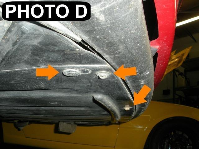 Remove plastic fasteners in the front fender well as shown in Photo A with a