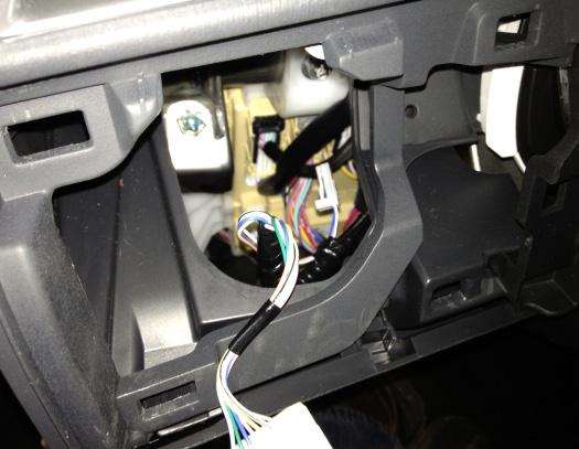 d. Find 4 pin connector inside of instrument panel and remove electrical tape (Fig. 4-3). Fig. 4-3 e. Install switch by pushing it into the opening in the mirror control panel (Fig.