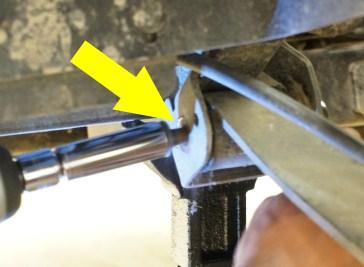 12. Once the hole and castle nut are aligned, insert the Cotter Pin. Do not reconnect the brake cable. 13. Place the leaf spring on top of the axle.