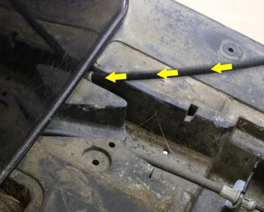 Under the driver side of the cart, locate the plastic channel on the outside edge of the