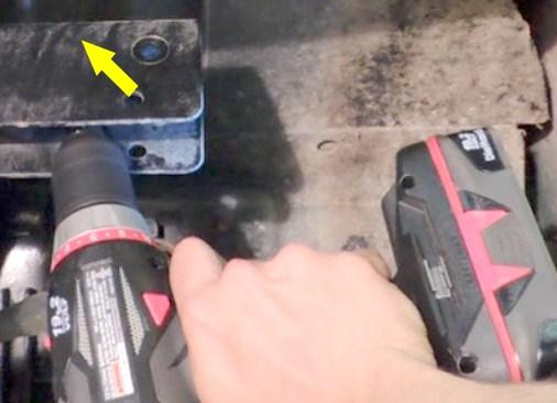 7. Use a center punch and to mark the location of the hole. 8. Wearing safety glasses, drill a 1/8-3/16 pilot hole through the cross frame at the marked location. 9.
