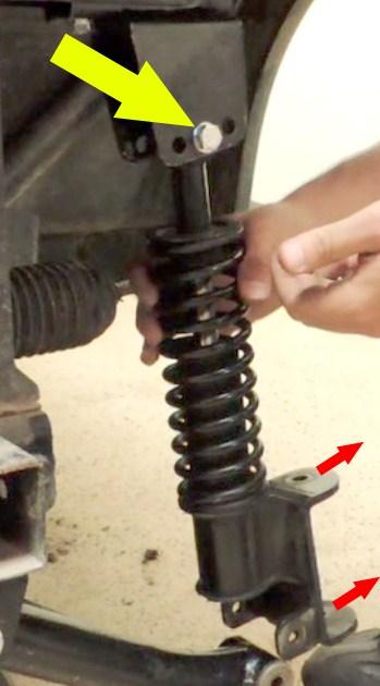 NOTE: The larger round mounting tabs of the shocks will face away from the cart. 18.