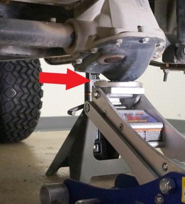Place a jack securely under the rear axle. Safely lift the rear end of the cart enough to accommodate the additional height of the larger tires and wheels. 6.