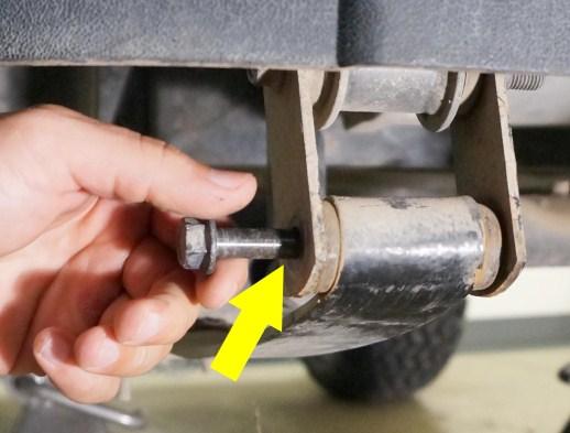 Remove the front portion of the leaf spring by removing the bolt on the front shackle. Remove the leaf spring.