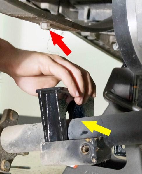 Place a riser block on top of the axle and under the leaf spring.