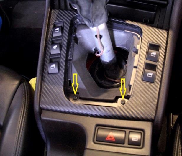 Pull gently up on one corner of the leather gear shift boot until the clips pull free.