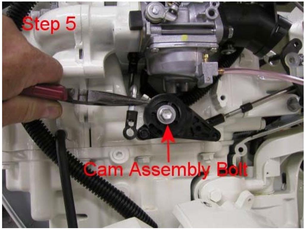 4. Below the carburetor, locate the plastic cam that operates the vertical push rod. This rod is attached by a Snap-On ball and socket. Snap the rod off the ball. 5.