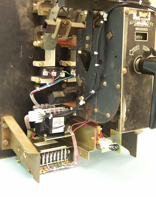 CT Harness up along the left side of the Breaker Center Mechanism, then across the top of the Center Mechanism to the right side of the Trip Unit. Plug the connector from the Aux.