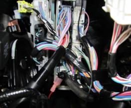 Using a 14 wire tie, secure the driver box to left side of lowered dash