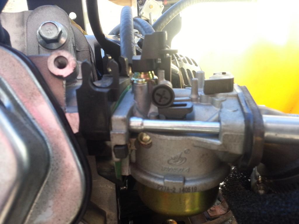 The Black plastic screw on the top of your carburetor controls your idle speed.