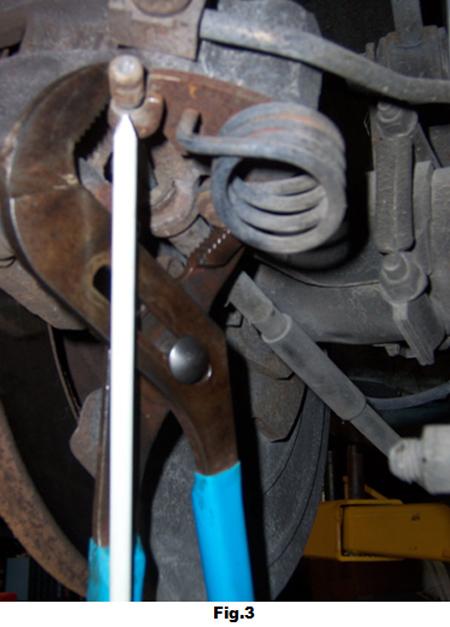 6. Using adjustable pliers, squeeze together the parking brake lever and remove the
