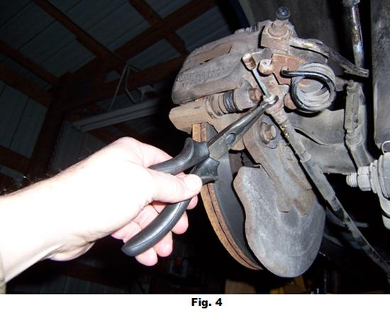 7. If you are planning to replace brake pads, then the two caliper retaining pins should now be removed.
