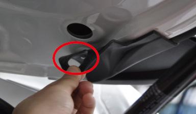 13. Remove the rubber plug from the lift gate above the lift motor.
