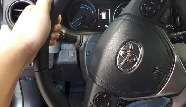 by rotating the steering wheel 90 degrees to the right.