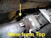 8) Remove the nut securing the upper bracket of the EGR canister