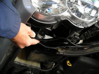 To remove headlights from vehicle for ease of joining indicator looms and extending fog light looms, firstly