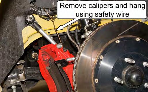 NOTE: Make sure that the calipers are located so that the suspension can be compressed without interference. 9.