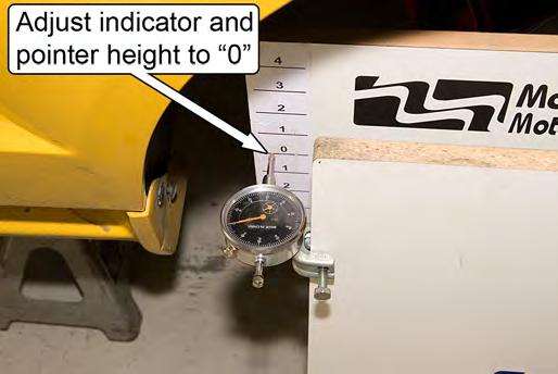 26. Adjust the vertical positions of the dial indicator and the pointer on the gauge so their tips are at the same height as the 0 (normal ride height) marks on the reference plate.