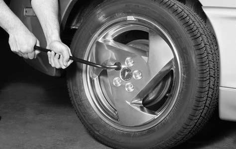 Removing the Flat Tire and Installing the Spare Tire 1. If your vehicle is equipped with wheel covers, use the wheel wrench to begin loosening the plastic wheel nut caps.
