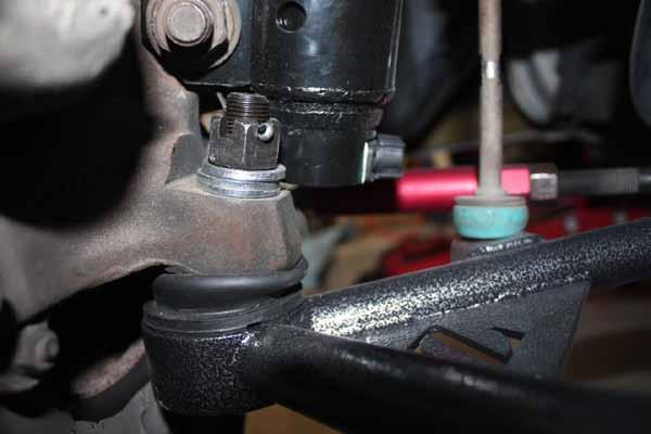 27. Install the ball joint into the spindle and put on the nut and cotter key.