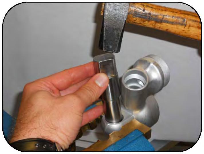 Using the correct size metal tool, tap out