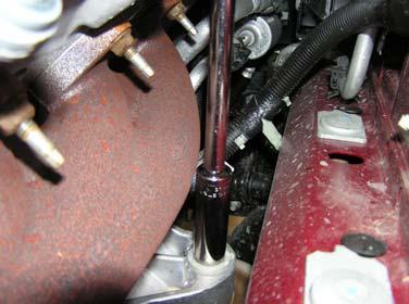 In addition, this is best time to gain access to the nuts that hold the motor mounts to vehicle frame. Remove these nuts from both the left and right sides of the engine.