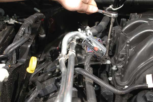 Use a 10mm socket to remove the fasteners holding the right hand side heater tube/wiring harness bracket to the engine.