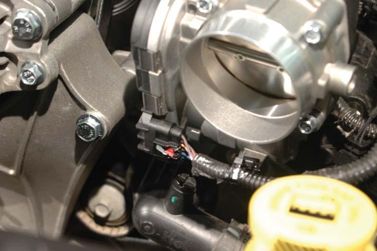 120. Reconnect the throttle body control harness to the throttle body and press the harness