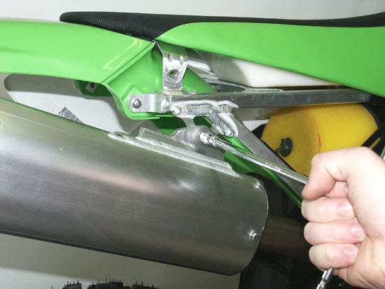 4. Unscrew and remove the bolt from the muffler