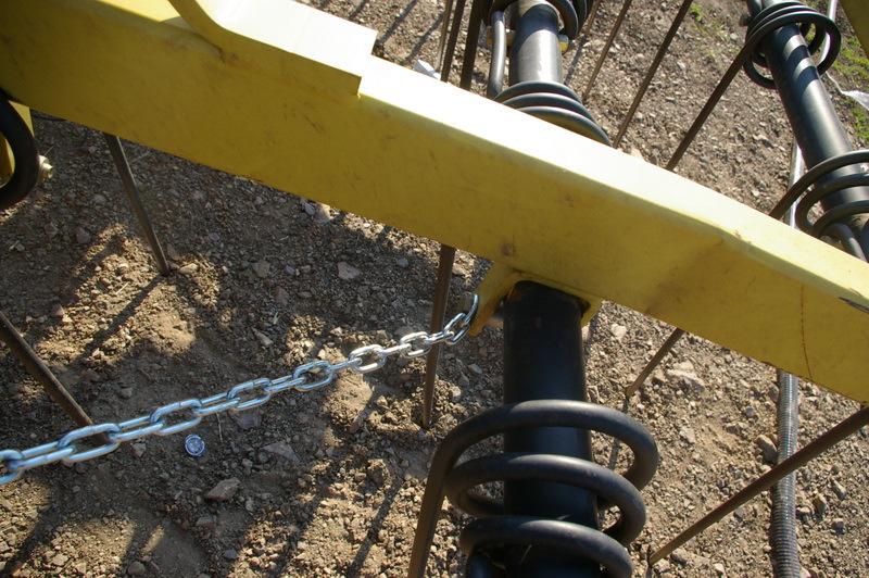 Attach Chain Here 10. Once the delivery hoses are clamped between the hose channels, fold the harrowbar a few times to check for snagging.
