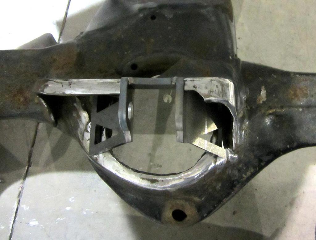 6. For 68-72 cars, skip step 6 and proceed to step 7. On 64-67 cars mark the width of the shock bolt area of the bracket on the upper control arm mount.