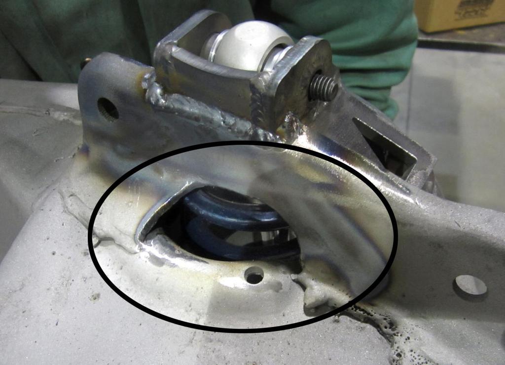 11. Depending on shock and spring combination, on some frames, it may be necessary to clearance the inner section of the control arm mount as seen in the photo below.