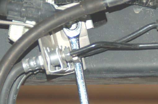 Install the brake line extension bracket on the frame
