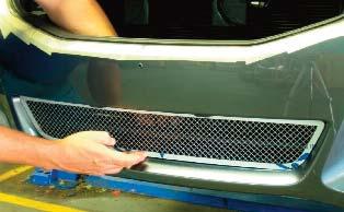 Before tighten the mounting hardware on the lower grille, remove any masking tape that could