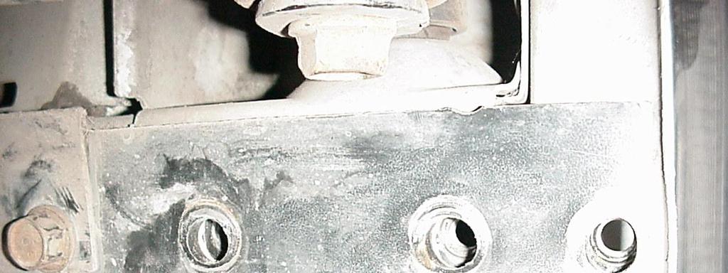 3. Once the square holes are cut, remove the back three bolts on the bottom of the subframe on the driver s side and back four bolts