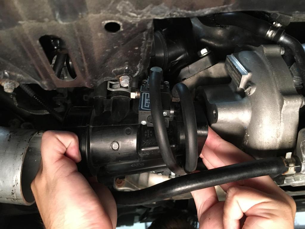 9. Next, remove the two 12mm bolts connecting