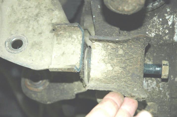 26. Using a 21mm wrench and socket remove the upper bolt that holds the differential. Remove the differential from the vehicle. Do not remove the passenger side differential bracket from the axle.