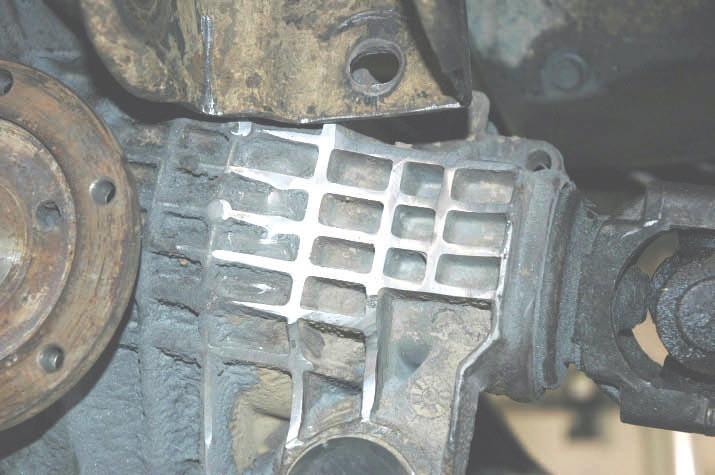 Using a grinder, trim down the fins on the drivers side of the differential as shown in Photo 19. Start by trimming about a 1/4, then trim to fit. 29.