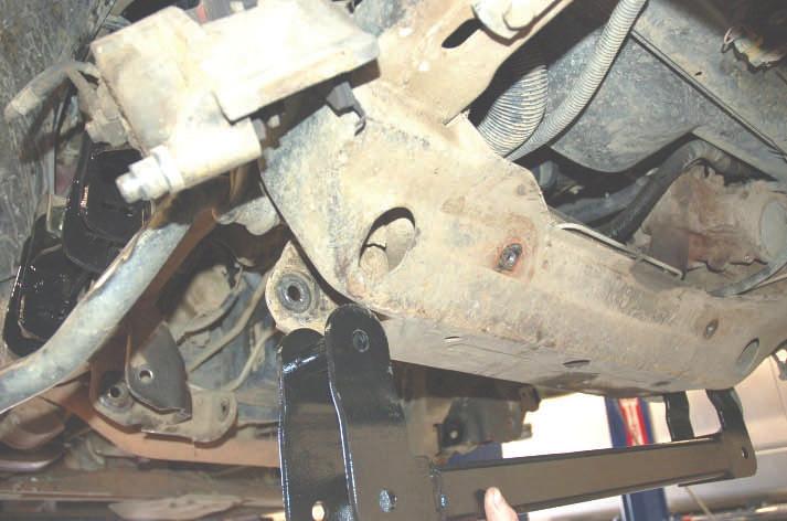 32. Place the driver side upper control arm drop bracket from 1274 Box 2, into the stock upper control arm brackets as seen in Photo 22 & 23.