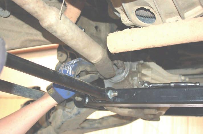 44. Swing up the bracket and insert the supplied crush sleeve in the frame rail for the existing hole on the upper control arm drop bracket Take care not to drop the sleeve inside the frame rail.