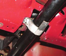 Photo #26: The top of the column is held to the dash with the stock clamp. On 1955-56 cars, there are upper and lower brackets with a rubber strap P/N 05-33 that wraps around the mast jacket.