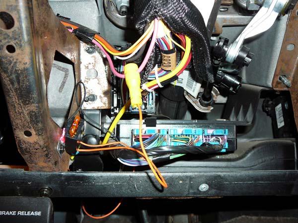IGNITION SWITCH WIRE: Remove the plastic cover from the front of the dash just under the steering column. Two screws hold this panel from the bottom. Two clips hold this panel to the dash.