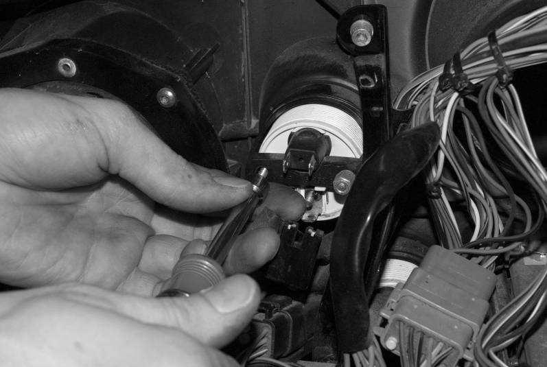 Unplug connectors at the back of the four small round gauges, then remove the two 5/16 nuts holding the